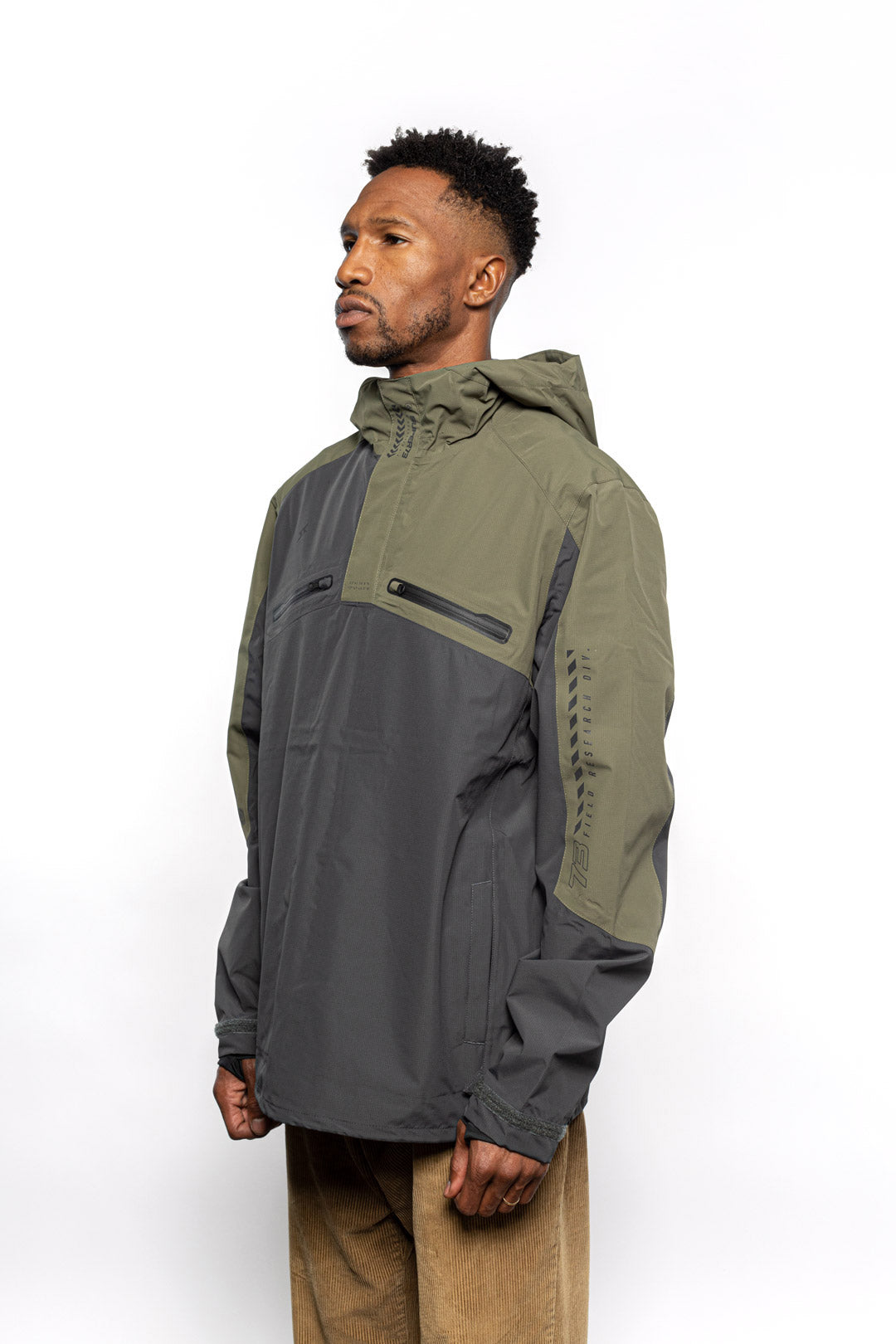 Side view of Male model wearing Vale Packable Anorak in Dark Fatigue colorway.